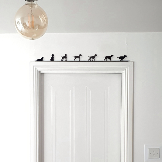 A set of German Wirehaired Pointers ornament made from recycled plastic displayed on top of a door frame