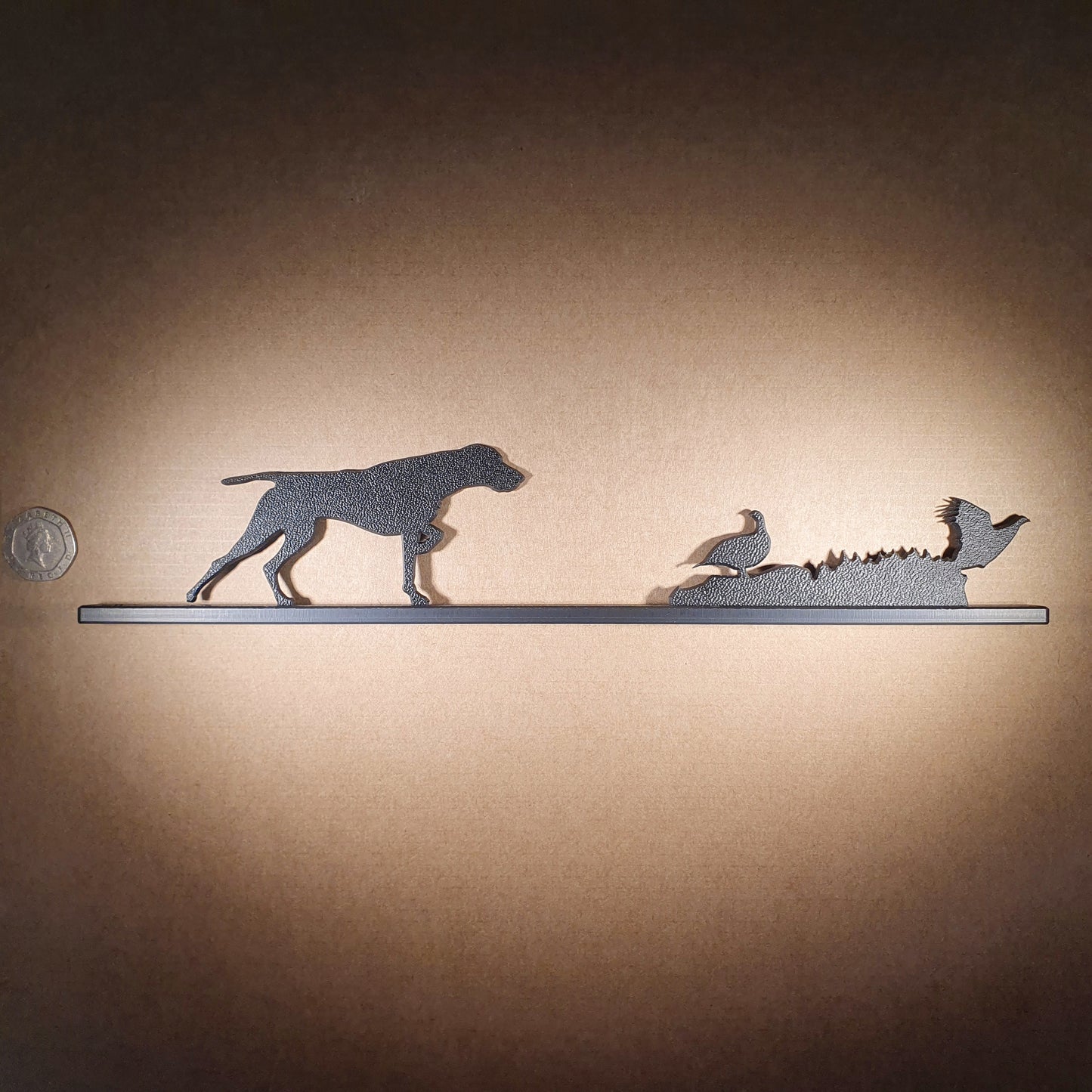 A German Pointer flushing grouse ornament made from recycled plastic pictured to display the products scale