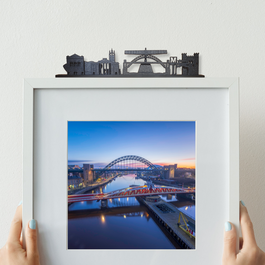 Newcastle skyline ornament made from recycled plastic displayed on top of a picture frame
